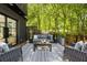 Outdoor living area on a wooden deck, complete with comfortable seating and patterned outdoor rug at 570 Martina Ne Dr, Atlanta, GA 30305