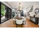 Elegant dining room with hardwood floors, modern lighting, and access to outdoor space at 570 Martina Ne Dr, Atlanta, GA 30305