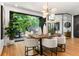 Bright dining room with hardwood floors, stylish lighting, and sliding doors to an outdoor space at 570 Martina Ne Dr, Atlanta, GA 30305