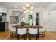 Dining area featuring a modern chandelier, light walls, hardwood floors, and view of the staircase at 570 Martina Ne Dr, Atlanta, GA 30305