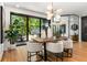 Bright dining room with hardwood floors, stylish lighting, and sliding doors to an outdoor space at 570 Martina Ne Dr, Atlanta, GA 30305