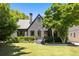 Attractive two-story home features a dark exterior, manicured lawn, and beautiful trees at 570 Martina Ne Dr, Atlanta, GA 30305