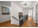 Bright upstairs hallway with hardwood floors, modern lighting, and contemporary artwork at 570 Martina Ne Dr, Atlanta, GA 30305