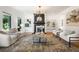 Spacious living room with a fireplace, hardwood floors, modern lighting, and stylish decor at 570 Martina Ne Dr, Atlanta, GA 30305