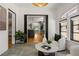Bright living room featuring white brick walls, arched windows, and modern furnishings at 570 Martina Ne Dr, Atlanta, GA 30305