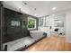 The main bathroom boasts a sleek, tiled shower, and modern soaking tub with ample natural light at 570 Martina Ne Dr, Atlanta, GA 30305