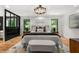 Inviting main bedroom featuring hardwood floors, modern lighting, and decorative black and wood furniture at 570 Martina Ne Dr, Atlanta, GA 30305