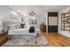 This is a main bedroom featuring a hardwood floor and neutral decor, plus modern light fixture at 570 Martina Ne Dr, Atlanta, GA 30305