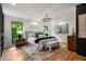Spacious main bedroom featuring hardwood floors, a modern chandelier, and black framed windows at 570 Martina Ne Dr, Atlanta, GA 30305