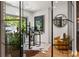 Well-lit office with glass walls, a skylight, a decorative rug, and a view of the yard at 570 Martina Ne Dr, Atlanta, GA 30305