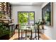 Office featuring a wine rack, a large window with a view of the greenery, and a glass desk at 570 Martina Ne Dr, Atlanta, GA 30305