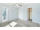 Bright bedroom with plush carpet, ceiling fan, and access to ensuite bathroom and closet at 6887 Slate Stone Se Way # 3, Mableton, GA 30126