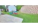 Backyard featuring a play structure with slide and grass with retaining wall in background at 779 Avonley Creek Trce, Sugar Hill, GA 30518