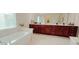 Spacious bathroom boasts double vanity with ample storage and large soaking tub for relaxation at 779 Avonley Creek Trce, Sugar Hill, GA 30518