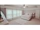 The bedroom boasts a tray ceiling, plush carpet, and large windows that fill the space with natural light at 779 Avonley Creek Trce, Sugar Hill, GA 30518