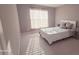 Bedroom featuring a neutral color scheme, large window, and carpeted floors at 779 Avonley Creek Trce, Sugar Hill, GA 30518