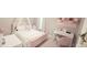 Charming pink bedroom with a cozy bed, elegant desk, and stylish decor for a sweet retreat at 779 Avonley Creek Trce, Sugar Hill, GA 30518