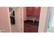 Walk-in closet adjacent to a bathroom with granite countertop cabinets at 779 Avonley Creek Trce, Sugar Hill, GA 30518