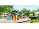Colorful playground with slides and climbing structures in a fenced area at 779 Avonley Creek Trce, Sugar Hill, GA 30518
