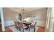 Elegant dining room featuring wainscoting, chandelier, and seating for eight, perfect for Gathering gatherings at 779 Avonley Creek Trce, Sugar Hill, GA 30518