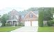 Beautiful two-story brick home with an attached two-car garage and well-kept landscaping at 779 Avonley Creek Trce, Sugar Hill, GA 30518