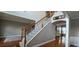 Inviting foyer with staircase featuring wood and iron railing and hardwood flooring at 779 Avonley Creek Trce, Sugar Hill, GA 30518
