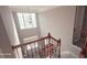 Bright, two-story foyer featuring large windows and an elegant staircase with iron balusters at 779 Avonley Creek Trce, Sugar Hill, GA 30518