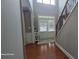 Bright, two-story foyer with a grand staircase and natural light streaming through large windows at 779 Avonley Creek Trce, Sugar Hill, GA 30518
