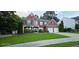 Charming two-story brick home with a well-manicured lawn and a two-car garage at 779 Avonley Creek Trce, Sugar Hill, GA 30518