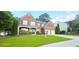 Beautiful brick home featuring a manicured lawn and a 'For Sale' sign at 779 Avonley Creek Trce, Sugar Hill, GA 30518