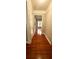 A well-lit hallway shows the beautiful hardwood floors that transition into a carpeted area at 779 Avonley Creek Trce, Sugar Hill, GA 30518