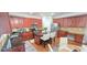 Spacious kitchen with dark wood cabinets, granite countertops, stainless steel appliances, and an island at 779 Avonley Creek Trce, Sugar Hill, GA 30518