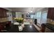 Open-concept kitchen with granite countertops, dark cabinets, and modern appliances, flowing into living area at 779 Avonley Creek Trce, Sugar Hill, GA 30518