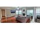 Bright living room with hardwood floors, a fireplace, and comfortable seating arrangement at 779 Avonley Creek Trce, Sugar Hill, GA 30518