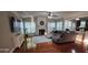 Spacious living room with hardwood floors, a fireplace, and large windows for natural light at 779 Avonley Creek Trce, Sugar Hill, GA 30518