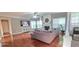 Open living room with hardwood floors, a fireplace, and large windows for natural light at 779 Avonley Creek Trce, Sugar Hill, GA 30518