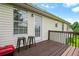 Exterior of a home showcasing a wooden deck with seating and a grill, with a pleasant view at 11072 Pebble Ridge Dr, Hampton, GA 30228