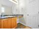 Bright bathroom features a vanity with wood cabinets, granite counters, and a large mirror at 11072 Pebble Ridge Dr, Hampton, GA 30228