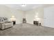 Comfortable bedroom showcasing plush carpeting, a cozy armchair, and stylish side tables with lamps at 11072 Pebble Ridge Dr, Hampton, GA 30228