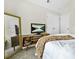 Bedroom with neutral colors features a console table and a full-length mirror at 11072 Pebble Ridge Dr, Hampton, GA 30228