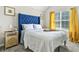 Cozy bedroom features a blue headboard, natural light, and stylish decor at 11072 Pebble Ridge Dr, Hampton, GA 30228