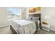 Bedroom with a large window with natural light, grey walls and neutral colored furniture at 11072 Pebble Ridge Dr, Hampton, GA 30228