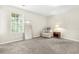 Serene bedroom with soft carpeting, a standing mirror, and a comfortable armchair by a bright window at 11072 Pebble Ridge Dr, Hampton, GA 30228