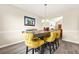 The dining room features a modern table with room to seat the whole Gathering at 11072 Pebble Ridge Dr, Hampton, GA 30228