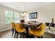 Dining room with modern light fixture and a view of the backyard at 11072 Pebble Ridge Dr, Hampton, GA 30228