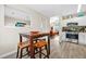 Bright eat-in kitchen features stainless steel appliances and a view to the living room at 11072 Pebble Ridge Dr, Hampton, GA 30228