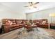 Spacious living room features comfortable seating, a ceiling fan, and a large window at 11072 Pebble Ridge Dr, Hampton, GA 30228
