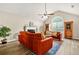 Comfortable living room with laminate floors, a ceiling fan, and large windows, providing a bright and airy atmosphere at 11072 Pebble Ridge Dr, Hampton, GA 30228