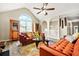 Bright living room featuring vaulted ceilings, modern furniture, laminate floors, and large windows for ample natural light at 11072 Pebble Ridge Dr, Hampton, GA 30228