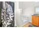 Bright and clean bathroom featuring a bathtub with shower and neutral decor at 11072 Pebble Ridge Dr, Hampton, GA 30228